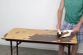 Man Sweeps Debris Off a Table Top HeÃ¢â¬â¢s Resurfacing